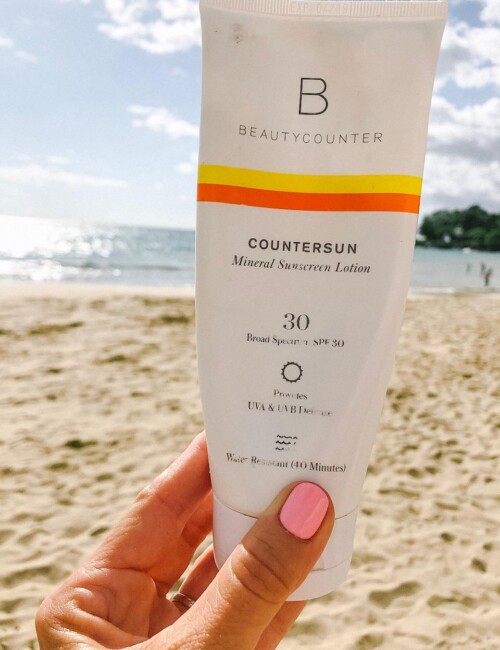 Beautycounter SPF packaging on the beach