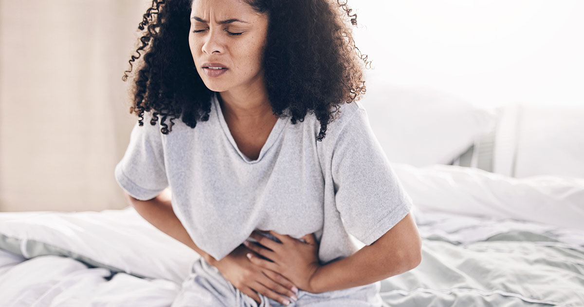 Abdomen pain, period and black woman in bed with abdominal cramps, irritable bowel syndrome, and stomach ache.