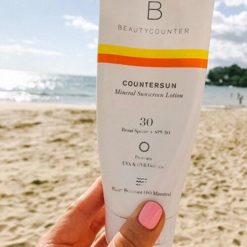 Beautycounter SPF packaging on the beach