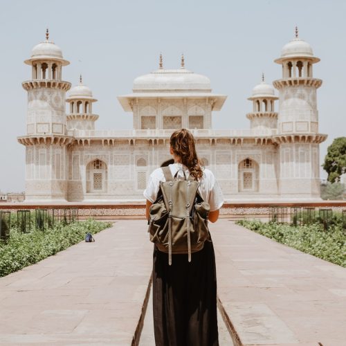 woman standing in front of temple for travel medicine