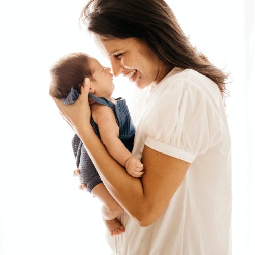 woman and baby smiling face to face